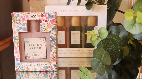 Collection of Kmart dupe fragrances displayed on a stylish vanity, showcasing affordable alternatives to high-end perfumes.